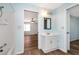 White vanity and a tub shower in this bathroom at 4251 Hamilton Mill Rd, Buford, GA 30519