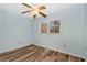 Bright bedroom with wood-look floors and two windows at 4251 Hamilton Mill Rd, Buford, GA 30519