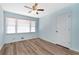 Bedroom with light blue walls, wood-look floors, and a large window at 4251 Hamilton Mill Rd, Buford, GA 30519