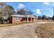 Ranch style home with gray siding, red door and carport at 4251 Hamilton Mill Rd, Buford, GA 30519