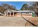 Ranch style home with gray siding, red door and carport at 4251 Hamilton Mill Rd, Buford, GA 30519