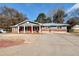 Ranch style home with gray siding, brick accents, and a red front door at 4251 Hamilton Mill Rd, Buford, GA 30519