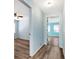 Light blue hallway with wood-look floors connecting bedrooms at 4251 Hamilton Mill Rd, Buford, GA 30519