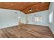 Open living area with vaulted wood ceilings and laminate flooring at 4251 Hamilton Mill Rd, Buford, GA 30519