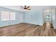 Bright living room featuring light blue walls, wood-look floors, and a ceiling fan at 4251 Hamilton Mill Rd, Buford, GA 30519