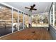 Relaxing screened porch with wooden deck and ceiling fan, overlooking backyard at 4251 Hamilton Mill Rd, Buford, GA 30519