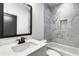 Bathroom with marble tile and built-in shelving at 1254 Prospect Rd, Lawrenceville, GA 30043