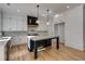 Modern kitchen with white cabinets, large island, and hardwood floors at 1254 Prospect Rd, Lawrenceville, GA 30043
