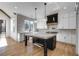 Modern kitchen with white cabinets, a large island, and hardwood floors at 1254 Prospect Rd, Lawrenceville, GA 30043