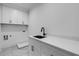 Laundry room with white cabinets and quartz countertop at 1254 Prospect Rd, Lawrenceville, GA 30043