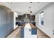 Contemporary kitchen with gray cabinetry, stainless steel appliances, and quartz countertops at 597 Hope Sw St, Atlanta, GA 30310