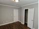 Bedroom with hardwood floors and two white doors, one leading to a closet at 149 Bixby Se Ter, Atlanta, GA 30317