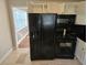 Kitchen with black appliances, white cabinetry, and tile flooring at 149 Bixby Se Ter, Atlanta, GA 30317