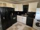 A kitchen with white cabinets, black appliances, and black tile backsplash at 149 Bixby Se Ter, Atlanta, GA 30317