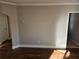Living room with hardwood floors, neutral walls, and an arched doorway at 149 Bixby Se Ter, Atlanta, GA 30317