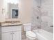 Updated bathroom with tub, white vanity, and marble tile at 1786 Ledo Ave, Decatur, GA 30035