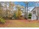 Large backyard with a wooden fence and fall foliage at 3972 Glenwood Downs Ln, Decatur, GA 30035