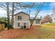 Home's backyard with mature trees and level yard at 3972 Glenwood Downs Ln, Decatur, GA 30035