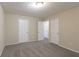 Well-lit bedroom with two closets and carpet flooring at 3972 Glenwood Downs Ln, Decatur, GA 30035