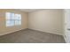 Spacious bedroom featuring a large window and carpet flooring at 3972 Glenwood Downs Ln, Decatur, GA 30035