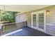 Back deck featuring wooden railings and access to the backyard through french doors at 6226 Pine Ln, Douglasville, GA 30135