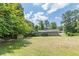 Large, grassy backyard with storage shed and mature trees at 6226 Pine Ln, Douglasville, GA 30135