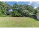 Expansive backyard with lush lawn, trees, and storage shed at 6226 Pine Ln, Douglasville, GA 30135