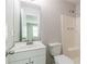 Simple bathroom with white vanity, toilet, and shower at 6226 Pine Ln, Douglasville, GA 30135