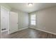 Unfurnished bedroom with a window and wood-look flooring at 6226 Pine Ln, Douglasville, GA 30135
