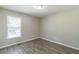 Unfurnished bedroom with window and wood-look floors at 6226 Pine Ln, Douglasville, GA 30135
