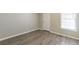 Empty bedroom with laminate flooring and a large window at 6226 Pine Ln, Douglasville, GA 30135