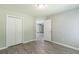 Empty bedroom with closet and wood-look flooring at 6226 Pine Ln, Douglasville, GA 30135