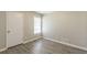 Unfurnished bedroom with wood-look flooring and window at 6226 Pine Ln, Douglasville, GA 30135