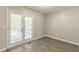 Dining area with wood-look flooring and french doors leading to the backyard at 6226 Pine Ln, Douglasville, GA 30135