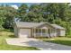 One-story home with attached garage, covered porch, and manicured landscaping at 6226 Pine Ln, Douglasville, GA 30135