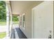 Covered front porch with white columns, a white front door, and sidelights at 6226 Pine Ln, Douglasville, GA 30135