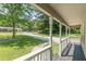 Front porch offering views of the surrounding neighborhood and trees at 6226 Pine Ln, Douglasville, GA 30135
