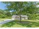Quaint single-story home nestled among trees with a welcoming front porch at 6226 Pine Ln, Douglasville, GA 30135