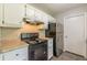 Updated kitchen with white cabinets, granite countertops, and black appliances at 6226 Pine Ln, Douglasville, GA 30135