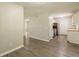 Open kitchen and dining area with wood-look flooring and stainless steel appliances at 6226 Pine Ln, Douglasville, GA 30135