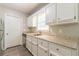 Bright kitchen featuring white cabinetry, granite counters, and stainless steel appliances at 6226 Pine Ln, Douglasville, GA 30135