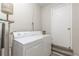 Laundry room with white washer and dryer and gray flooring at 6226 Pine Ln, Douglasville, GA 30135