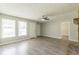 Spacious living room with wood-look flooring, ceiling fan, and natural light at 6226 Pine Ln, Douglasville, GA 30135