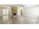 Living room with a stone fireplace, wood-look flooring, and access to the back deck at 6226 Pine Ln, Douglasville, GA 30135