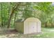 Storage shed nestled among trees in the backyard at 6226 Pine Ln, Douglasville, GA 30135