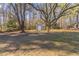 Spacious backyard with a large tree and storage shed at 8661 Chestnut Ln, Lithia Springs, GA 30122