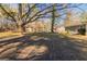 Large backyard with mature trees and a storage shed at 8661 Chestnut Ln, Lithia Springs, GA 30122