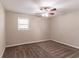 Spacious bedroom with ceiling fan and neutral carpeting at 8661 Chestnut Ln, Lithia Springs, GA 30122
