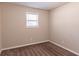 Simple bedroom with neutral walls and brown carpeting at 8661 Chestnut Ln, Lithia Springs, GA 30122