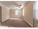 Bright bedroom with neutral carpeting, exposed brick wall, and ceiling fan at 8661 Chestnut Ln, Lithia Springs, GA 30122